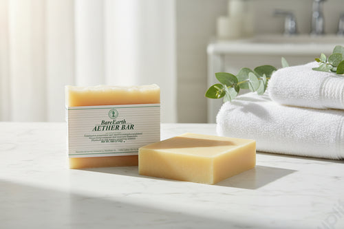 Aether eucalyptus soap bars on white marble bathroom counter with folded towels and eucalyptus