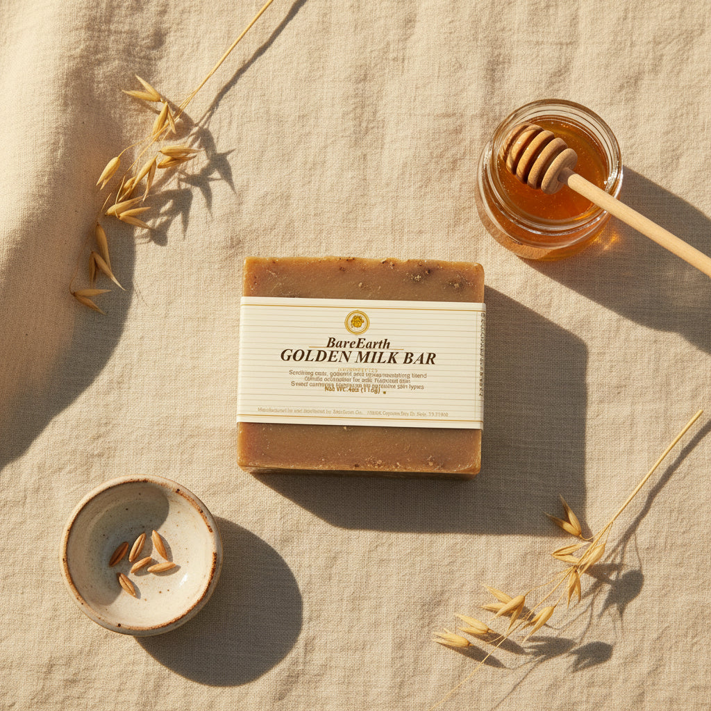 Golden Milk soap bar with honey jar, oats, and ceramic dish on cream linen flat-lay